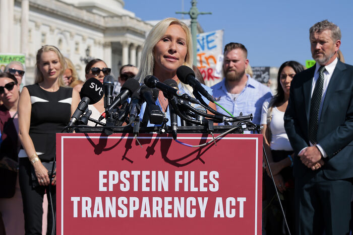 Marjorie Taylor Greene speaking at a podium about Epstein Files Transparency Act, addressing GOP men and her resignation defense. Marjorie Taylor Greene speaking at a podium about Epstein Files Transparency Act, addressing GOP men and her resignation defense.