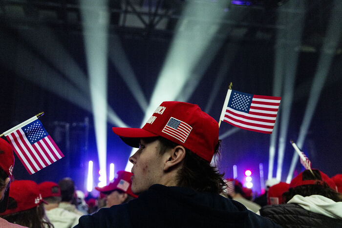 Supporters wearing red hats with American flags at a political event amid social media roasts involving Tomi Lahren. Supporters wearing red hats with American flags at a political event amid social media roasts involving Tomi Lahren.