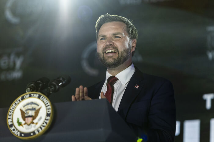 Man speaking at a podium with Vice President of the United States seal, related to Vance Clan and Cincinnati election news.