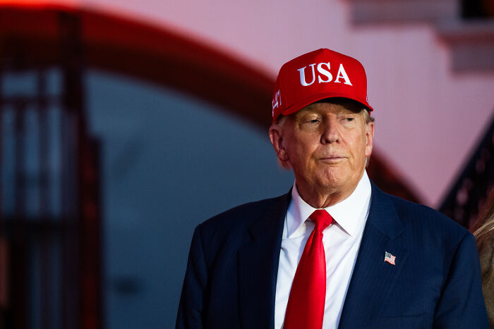 Donald Trump wearing a red USA hat and suit, representing National Guard orders in Washington until end of February. Donald Trump wearing a red USA hat and suit, representing National Guard orders in Washington until end of February.