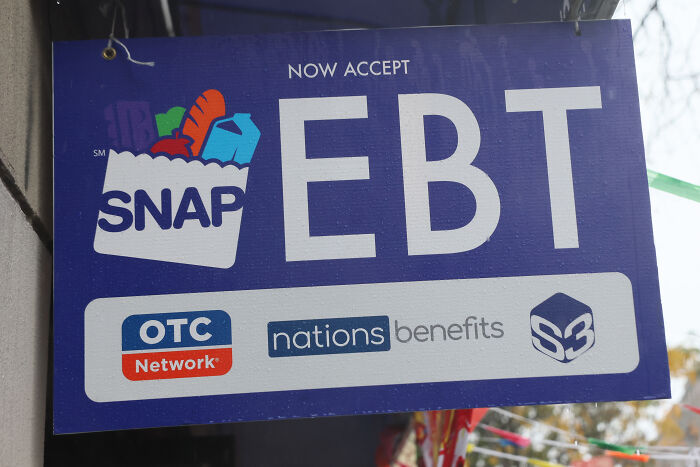 Sign displaying SNAP EBT acceptance, highlighting benefits related to nutrition assistance and OTC Network support. Sign displaying SNAP EBT acceptance, highlighting benefits related to nutrition assistance and OTC Network support.