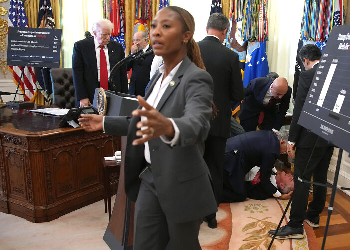 Donald Trump in Oval Office with a man fainting behind him and people attending to the situation quickly. Donald Trump in Oval Office with a man fainting behind him and people attending to the situation quickly.