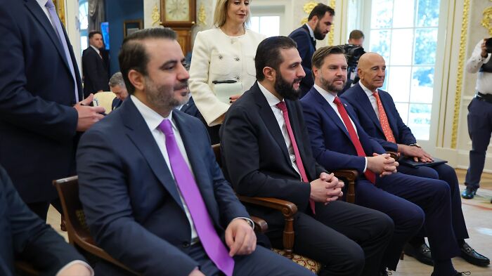 Syrian President and delegates seated in a formal White House meeting discussing diplomatic relations with Trump. Syrian President and delegates seated in a formal White House meeting discussing diplomatic relations with Trump.