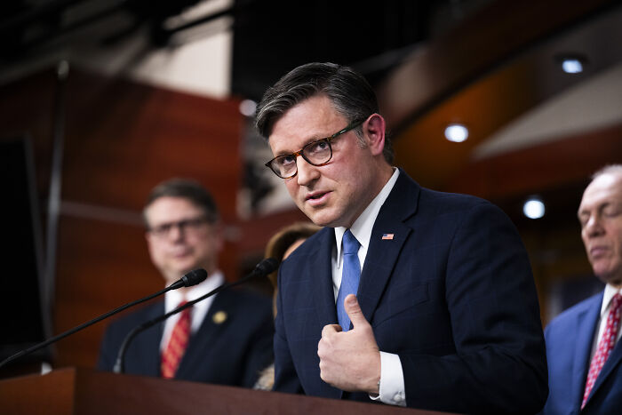 Man in suit and glasses speaking at podium during congressional session on Epstein files and related vote. Man in suit and glasses speaking at podium during congressional session on Epstein files and related vote.