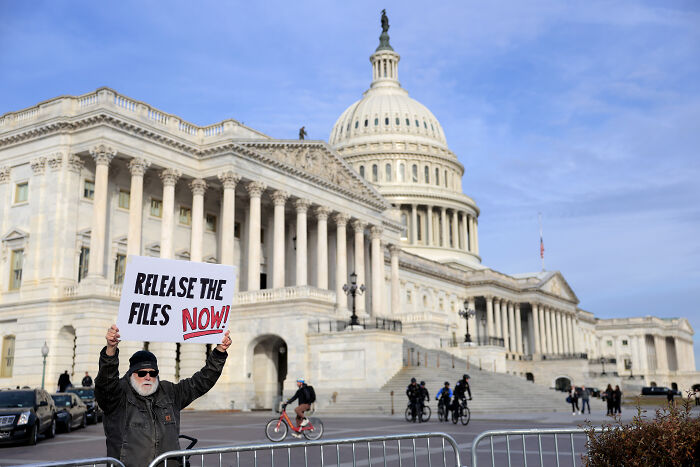 Protester outside Capitol holding release the files sign, referencing Trump and Congressional vote on Epstein files. Protester outside Capitol holding release the files sign, referencing Trump and Congressional vote on Epstein files.