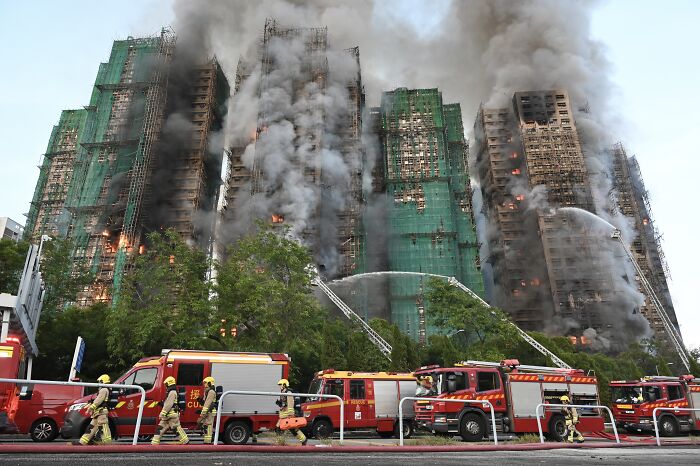 Firefighters battle a massive fire at a Hong Kong apartment complex with rising fatalities reported by officials.
