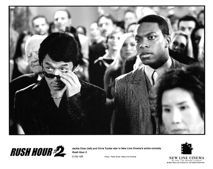 Black and white still from Rush Hour 2 featuring Jackie Chan and Chris Tucker in a crowded scene from the Hollywood movie franchise. Black and white still from Rush Hour 2 featuring Jackie Chan and Chris Tucker in a crowded scene from the Hollywood movie franchise.