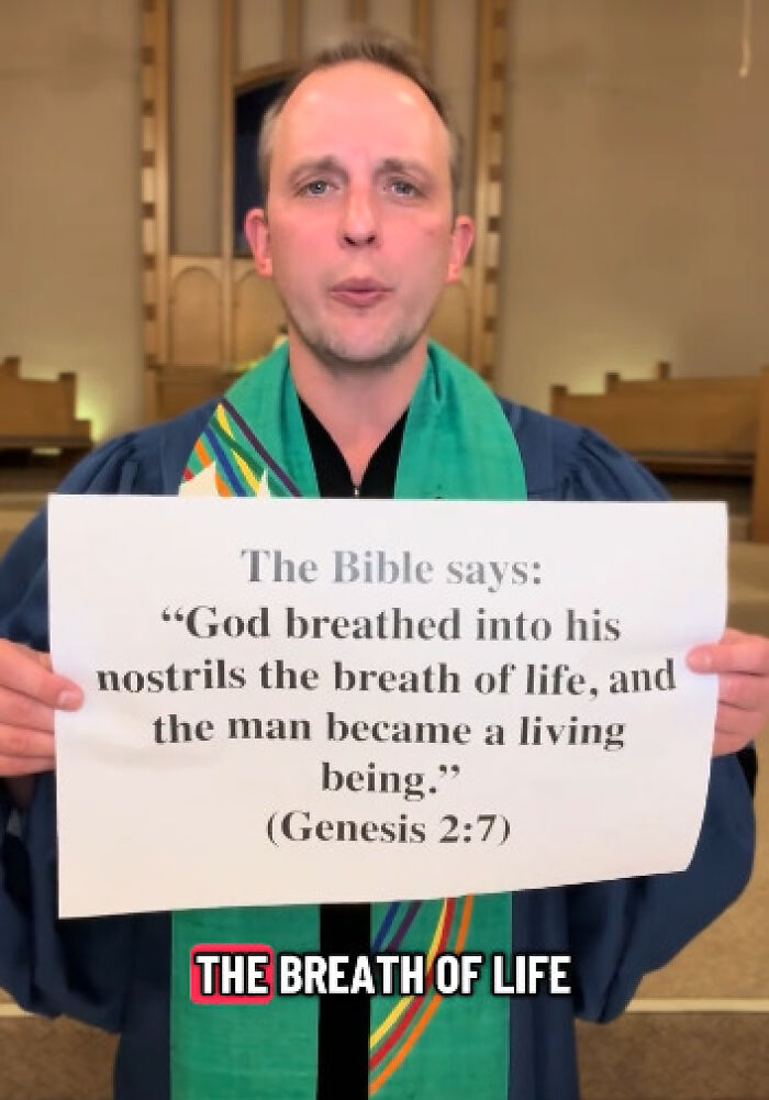 Reverend holding a Bible verse sign using scripture to oppose conservatives and share anti-MAGA message in church setting.