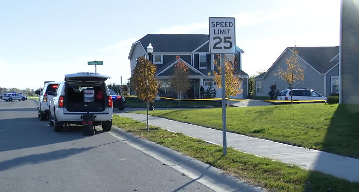 Crime scene with police vehicles and yellow tape outside a suburban home in Indiana after shooting incident involving house cleaner Crime scene with police vehicles and yellow tape outside a suburban home in Indiana after shooting incident involving house cleaner