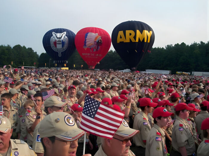 Large gathering of Boy Scouts at event with hot air balloons, illustrating topics on Boy Scouts and gender issues.