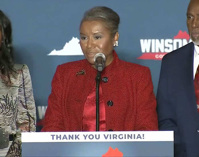 Female speaker at podium with thank you Virginia sign, highlighting Virginia turning blue in a sweeping victory against Trump. Female speaker at podium with thank you Virginia sign, highlighting Virginia turning blue in a sweeping victory against Trump.