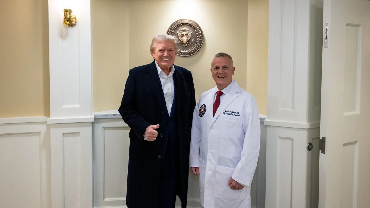 Former White House physician with Donald Trump posing indoors under presidential seal in formal attire and lab coat.