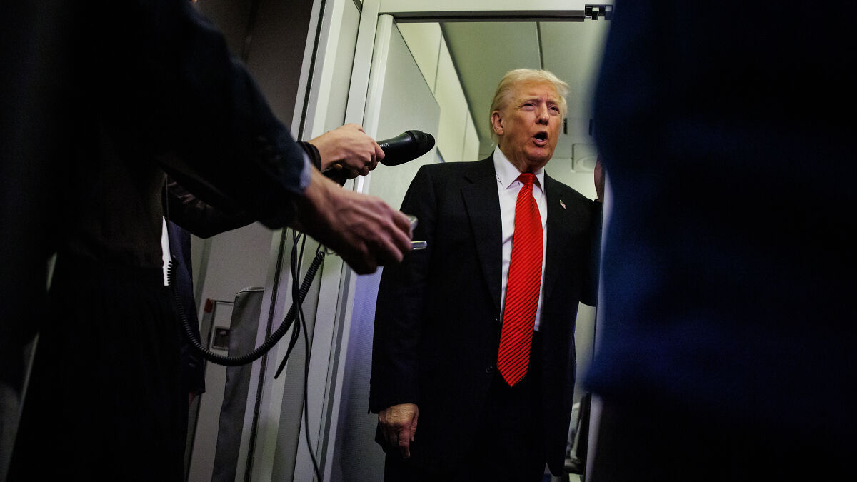 Donald Trump speaking to reporters, wearing a red tie and black suit, responding to Andrew losing prince title amid Epstein scandal.