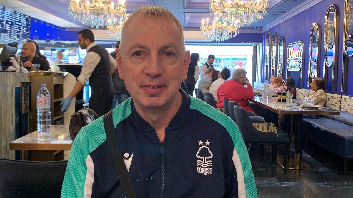 Train passenger sitting in a restaurant sharing his story of confronting a knife-wielding attacker as a true hero.