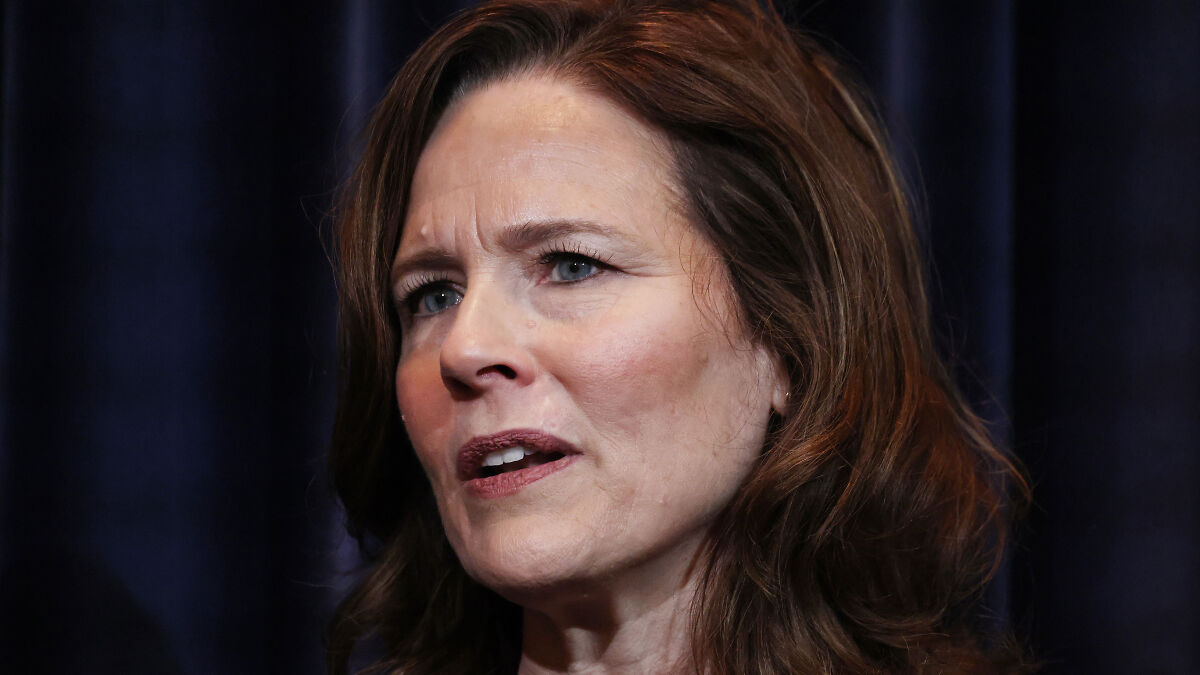 Justice Amy Coney Barrett speaking with concern over enormous Trump tax repayments in a formal setting.