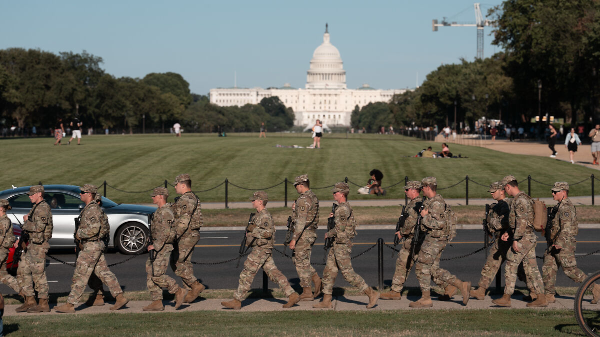 National Guard troops in uniform patrolling near the Capitol, representing National Guard orders in Washington.