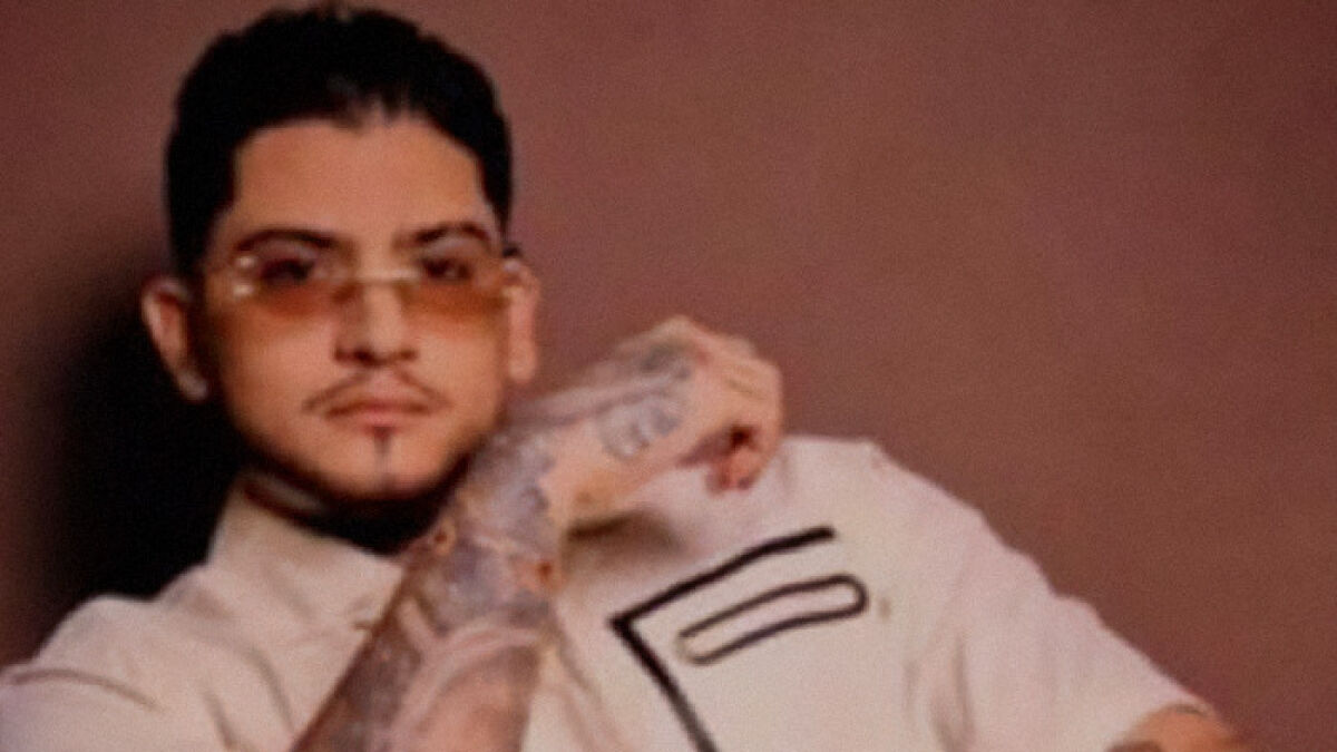 Young man with tattoos and sunglasses posing, related to Coco Chanel new substance linked to Colombian musician slayings.