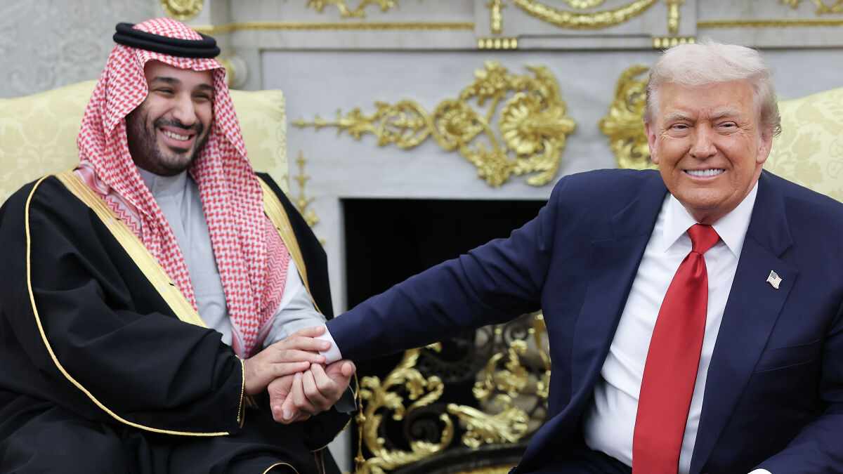 Donald Trump shaking hands with Saudi prince in a formal setting amid discussions on journalist Khashoggi controversy.