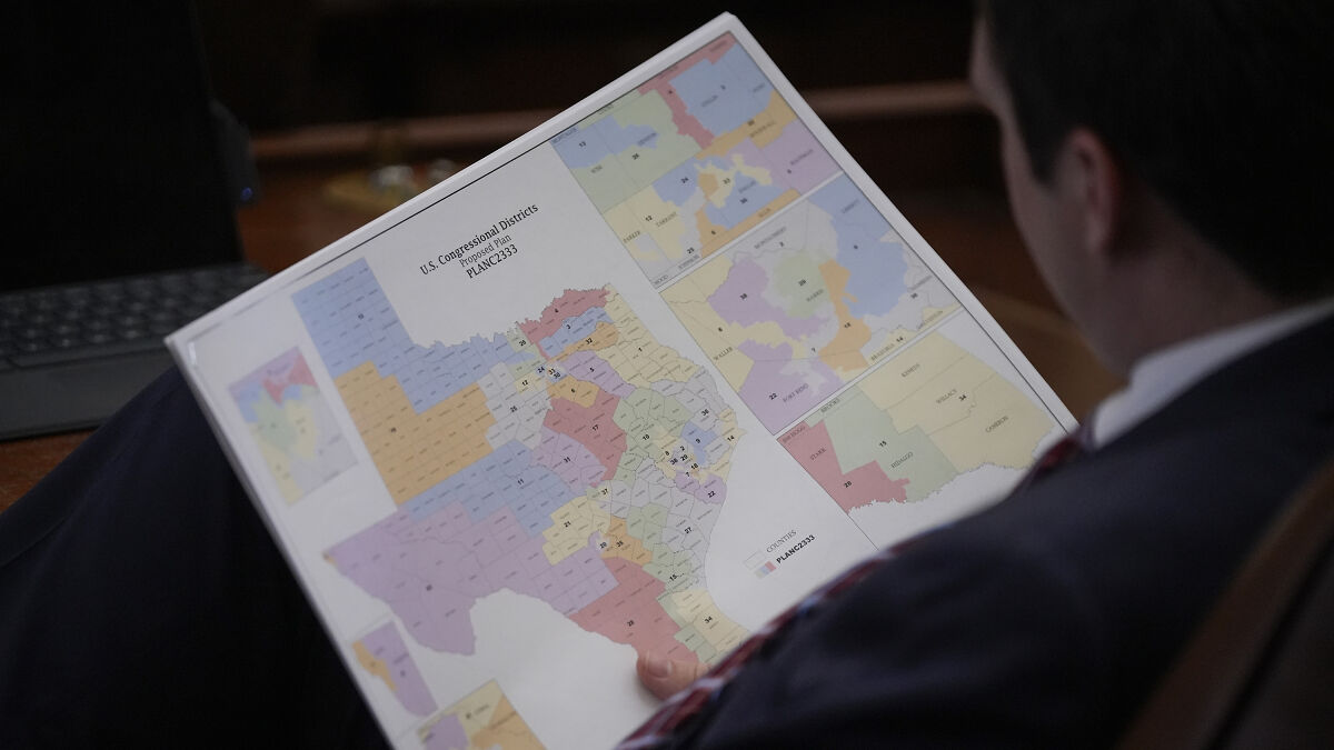 Person examining a detailed Texas congressional district map related to federal court ruling on racial gerrymandering.