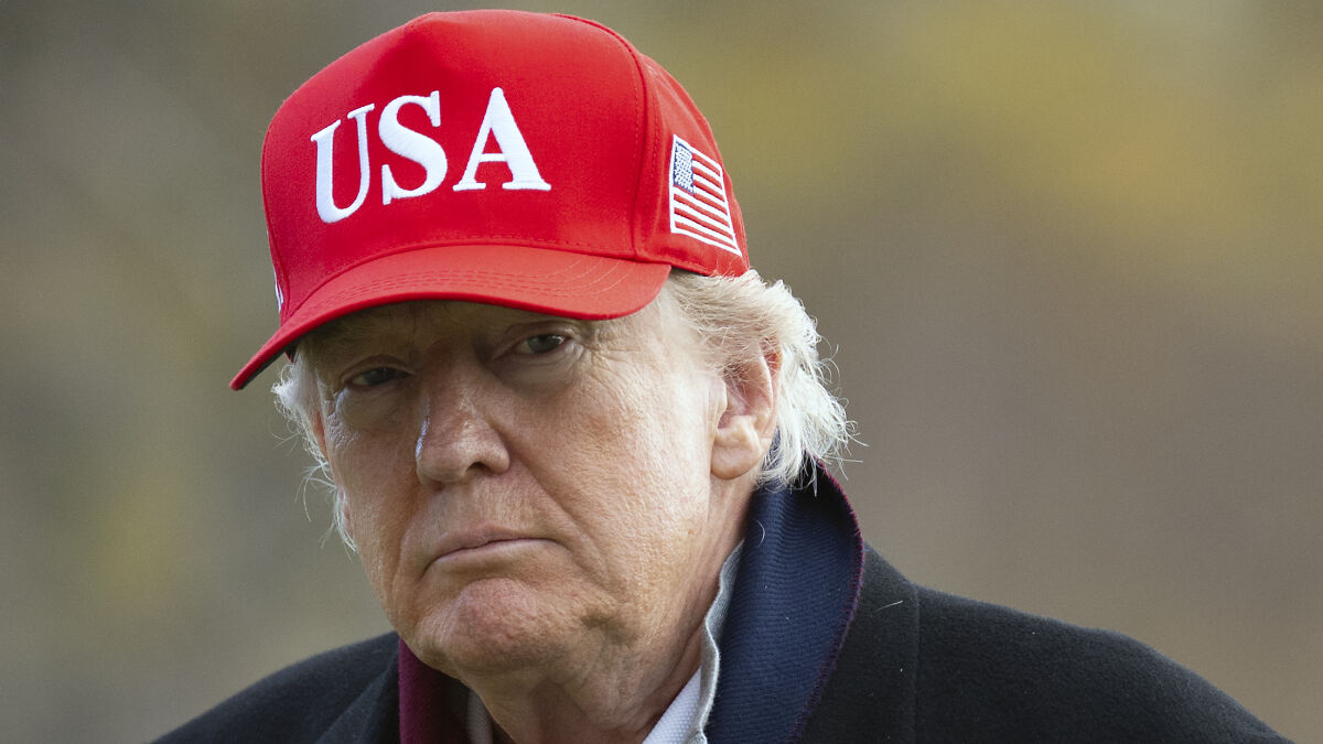 Donald Trump wearing a red USA cap, outdoors, associated with calls for return of Hollywood movie franchise.
