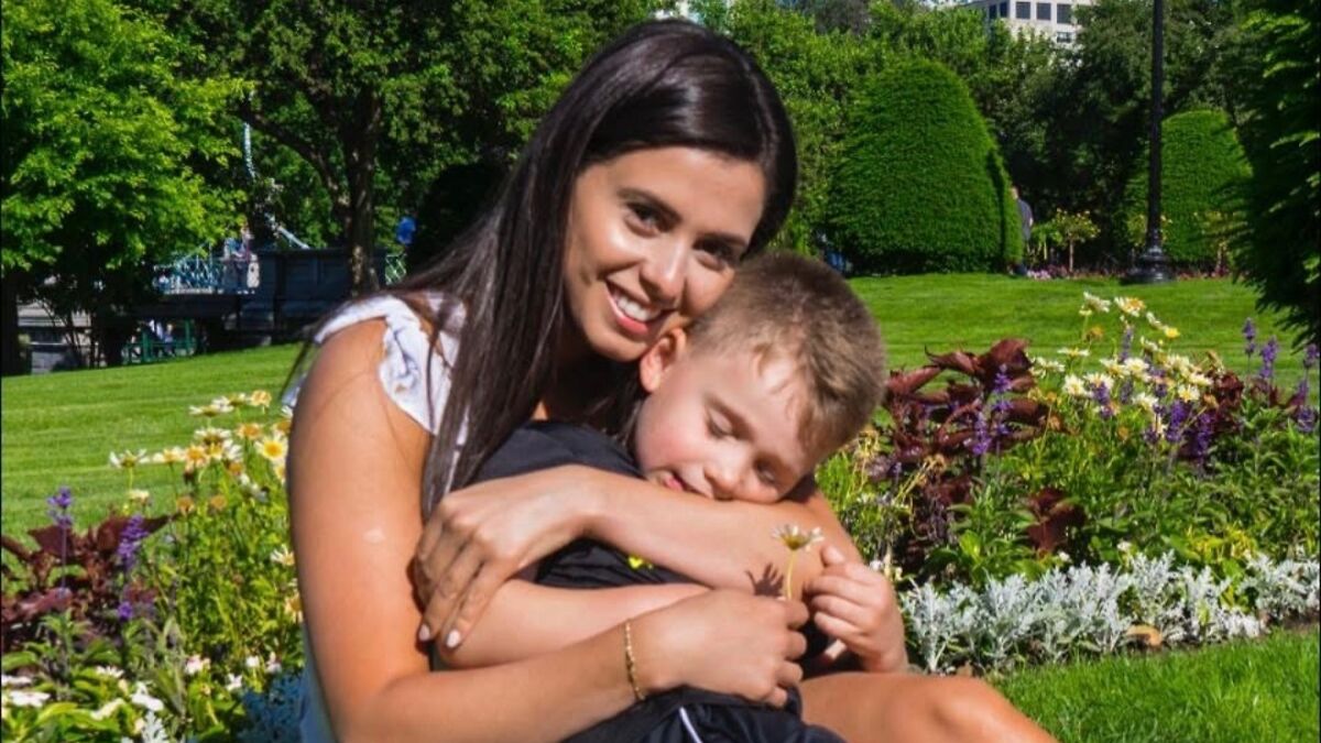 Karoline Leavittu2019s relative hugging a child outdoors in a garden before abrupt arrest by ICE after decades in US.