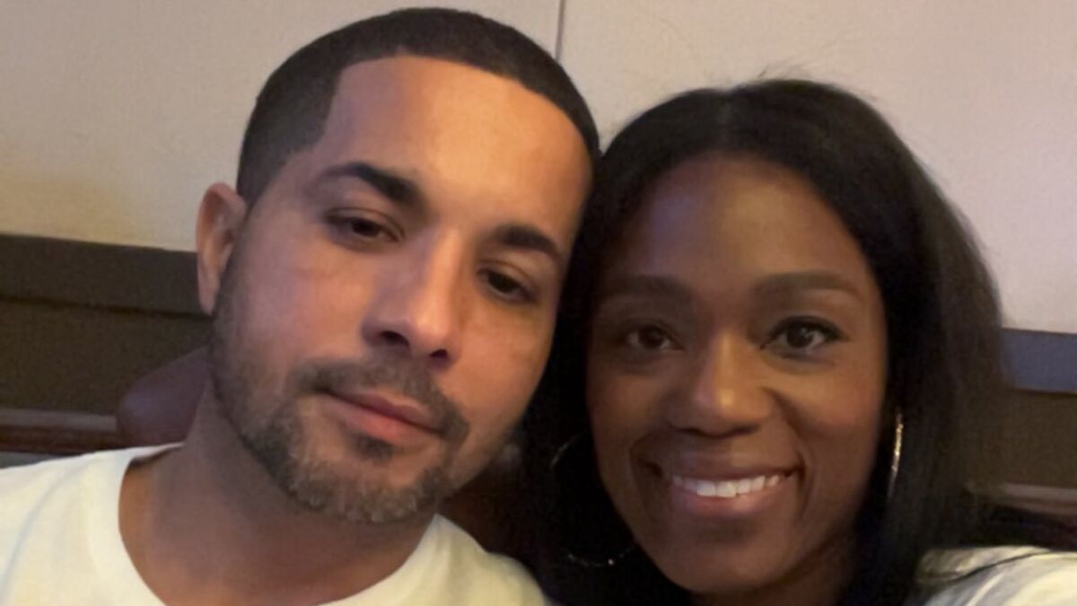A man and woman smiling closely together, representing a hero Navy sailor before drowning incident.