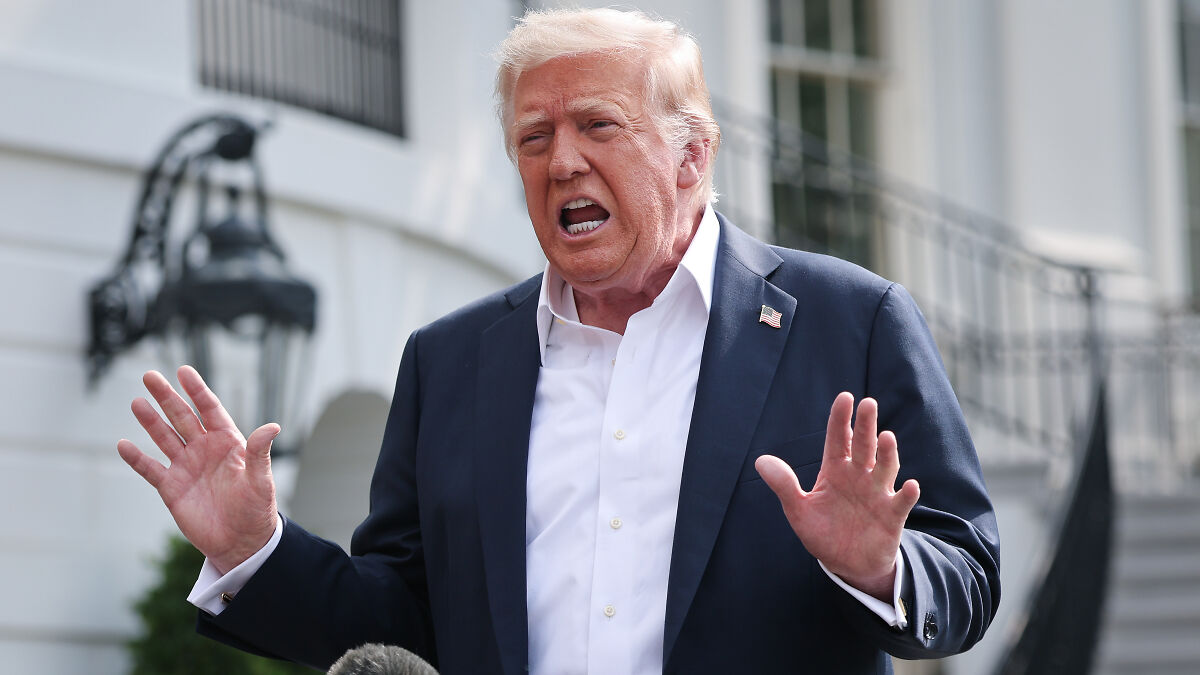 Former President Trump speaking outdoors near the White House, gesturing with hands during a discussion about ballroom architect clash.