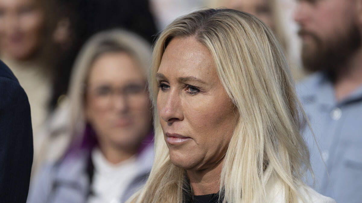 Marjorie Taylor Greene speaking at an event, addressing GOP men and defending her resignation decision.