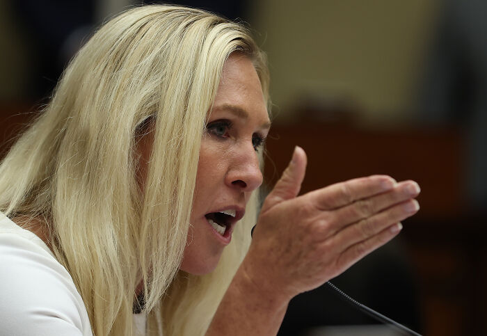 Marjorie Taylor Greene speaking passionately during a hearing, expressing a scathing response about Republicans losing elections.