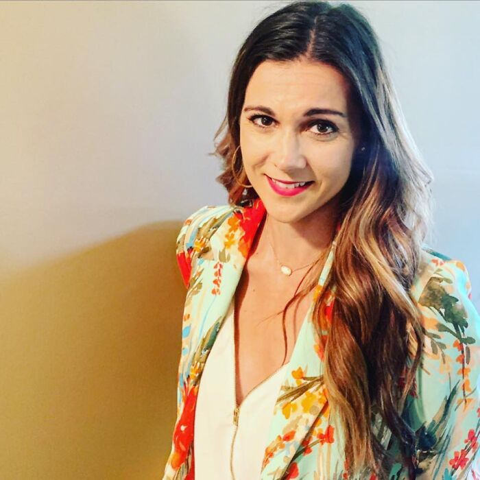 Female TV sports reporter smiling, wearing a floral jacket, representing beloved reporter found unresponsive at home. Female TV sports reporter smiling, wearing a floral jacket, representing beloved reporter found unresponsive at home.