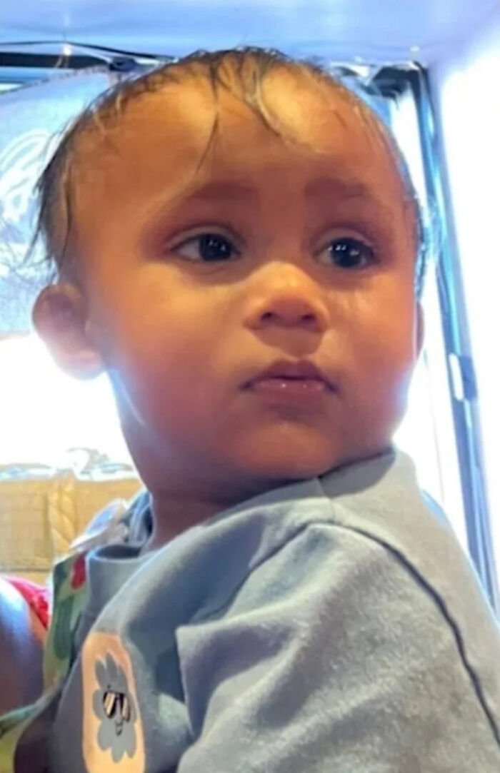 Infant boy looking to the side indoors, related to NYC mom accused of taking infant son's life before arrest.