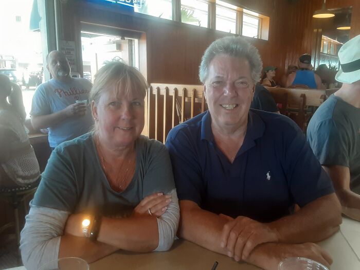 Middle-aged couple sitting at a restaurant table, relevant to daughter breaking silence after domestic dispute call news. Middle-aged couple sitting at a restaurant table, relevant to daughter breaking silence after domestic dispute call news.