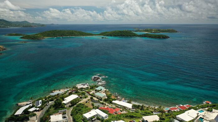 Aerial view of a tropical island with turquoise waters, linked to Democrats teasing Epstein bank records dump.