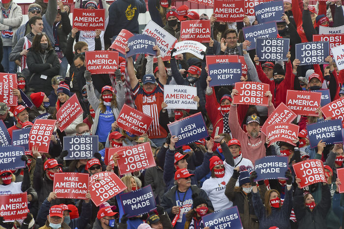 Large crowd of MAGA voters holding signs about jobs and promises at a rally amid 2024 grocery price complaint discussion. Large crowd of MAGA voters holding signs about jobs and promises at a rally amid 2024 grocery price complaint discussion.