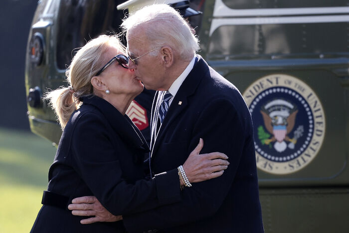 Joe Biden and Jill Biden embracing and kissing outdoors near a helicopter, related to daughter breaking silence after domestic dispute death. Joe Biden and Jill Biden embracing and kissing outdoors near a helicopter, related to daughter breaking silence after domestic dispute death.