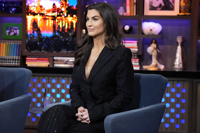 Reporter dressed in black suit sitting in a studio setting, responding after Trump branded her stupid and nasty.
