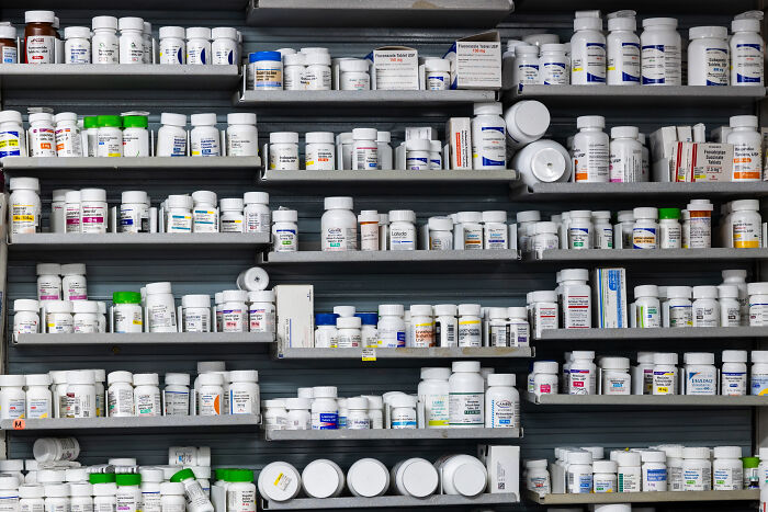Rows of prescription medication bottles and containers on pharmacy shelves, symbolizing claims and controversies from Trump. Rows of prescription medication bottles and containers on pharmacy shelves, symbolizing claims and controversies from Trump.