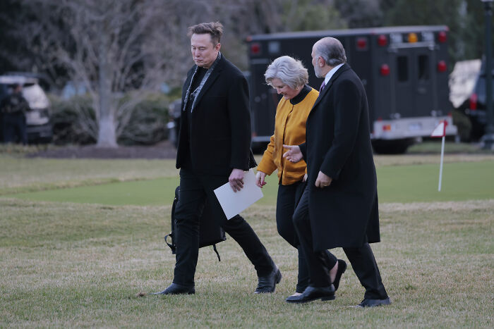 Three people walking outdoors near a golf green, illustrating Trump’s chief of staff backpedaling after snitching claims. Three people walking outdoors near a golf green, illustrating Trump’s chief of staff backpedaling after snitching claims.