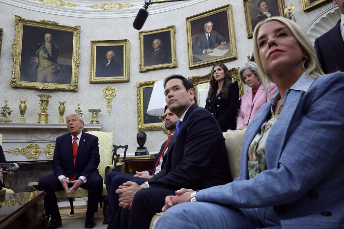 Trump’s chief of staff sitting with officials in a formal room amid discussions on political and leadership issues. Trump’s chief of staff sitting with officials in a formal room amid discussions on political and leadership issues.