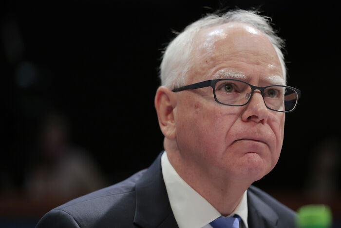 Man in glasses and suit at a hearing focused on Minnesota child care funds and allegations of widespread fraud. Man in glasses and suit at a hearing focused on Minnesota child care funds and allegations of widespread fraud.