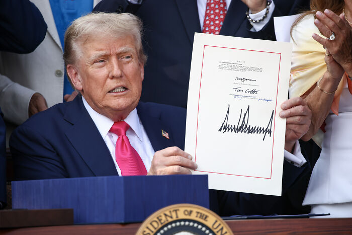 Former president holding signed document as IRS agents face challenges with x-rated content and no tax on tips claims Former president holding signed document as IRS agents face challenges with x-rated content and no tax on tips claims