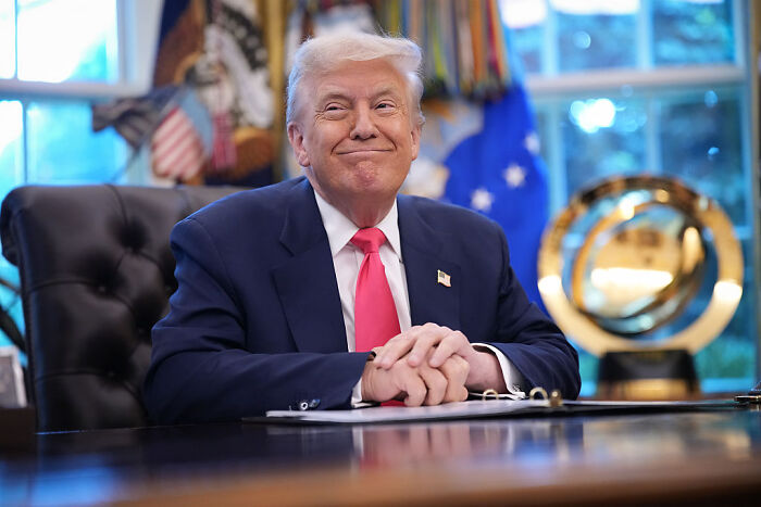 Donald Trump smiling at a desk in the White House, referencing his health compared to Barack Obama. Donald Trump smiling at a desk in the White House, referencing his health compared to Barack Obama.