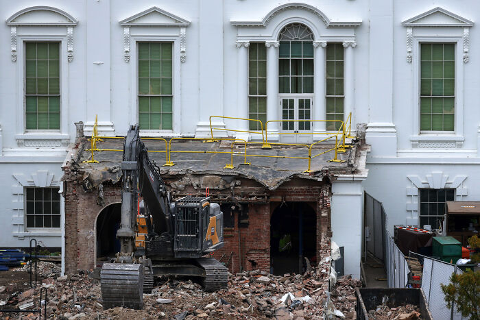 Excavator and debris outside White House during ballroom construction declared a security necessity by Trump administration. Excavator and debris outside White House during ballroom construction declared a security necessity by Trump administration.