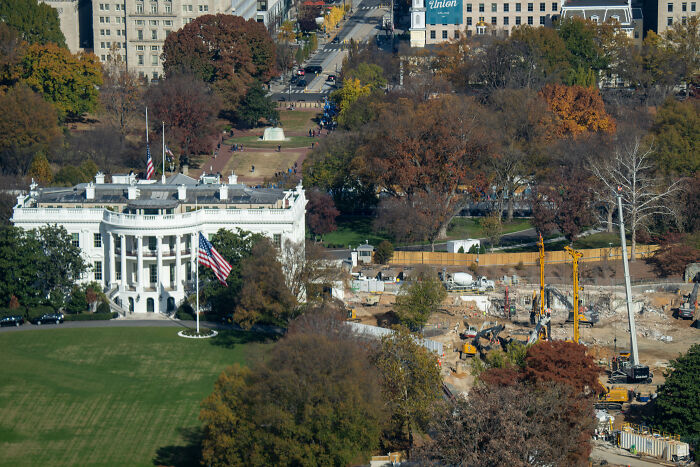 White House construction site during daylight with cranes and equipment, highlighting ballroom construction as a security necessity. White House construction site during daylight with cranes and equipment, highlighting ballroom construction as a security necessity.