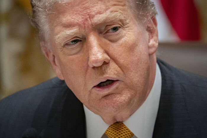 Donald Trump in a close-up, speaking with a serious expression, struggling to recall refusing to answer reporter’s question. Donald Trump in a close-up, speaking with a serious expression, struggling to recall refusing to answer reporter’s question.