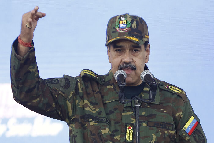 Venezuelan leader in military uniform giving a speech, related to U.S. land operation and major explosion in Venezuela.