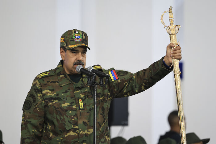 Man in military uniform speaking at microphone, holding a ceremonial sword, unrelated to Trump refusing reporter’s question. Man in military uniform speaking at microphone, holding a ceremonial sword, unrelated to Trump refusing reporter’s question.