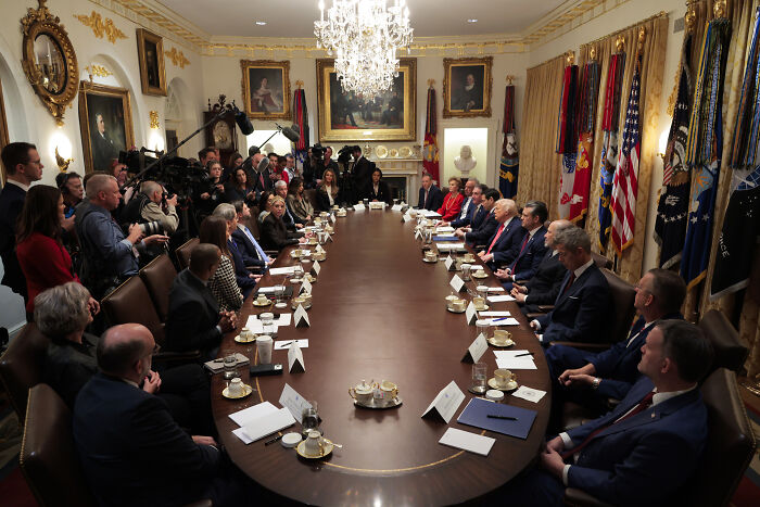Trump’s cabinet meeting in the White House with officials seated around a long table during a high-profile discussion.