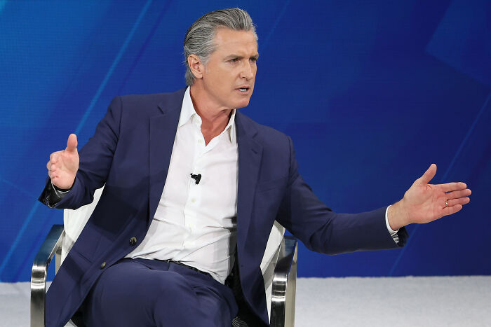 Gavin Newsom speaking passionately during an interview while addressing Halle Berry and women devaluing accusations.
