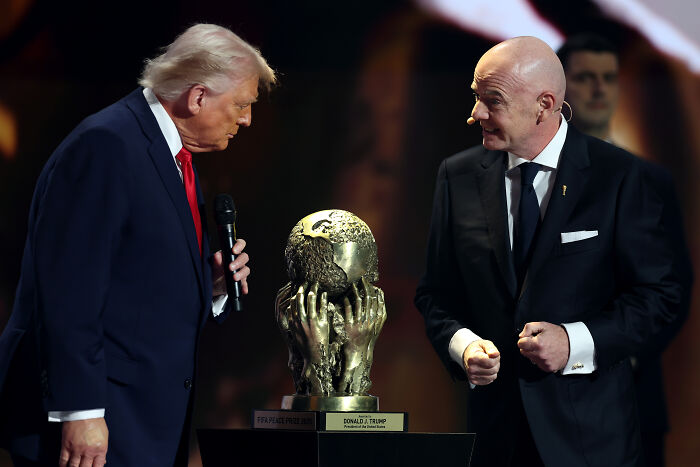 Donald Trump and Gianni Infantino near FIFA Peace Prize trophy during an award ceremony on stage. Donald Trump and Gianni Infantino near FIFA Peace Prize trophy during an award ceremony on stage.
